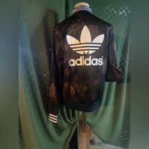 Adidas track jacket with intriguing fall leaf background or camouflage